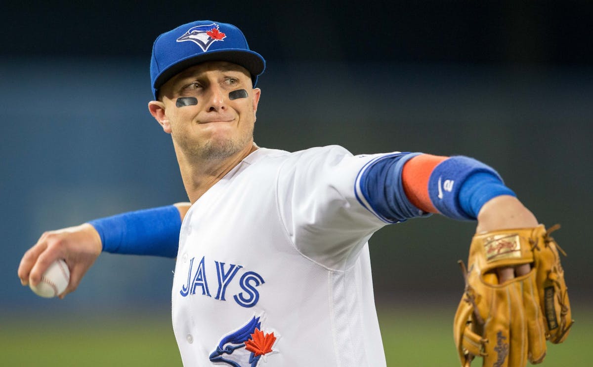 Troy Tulowitzki poses as a pitcher on Blue Jays' photo day