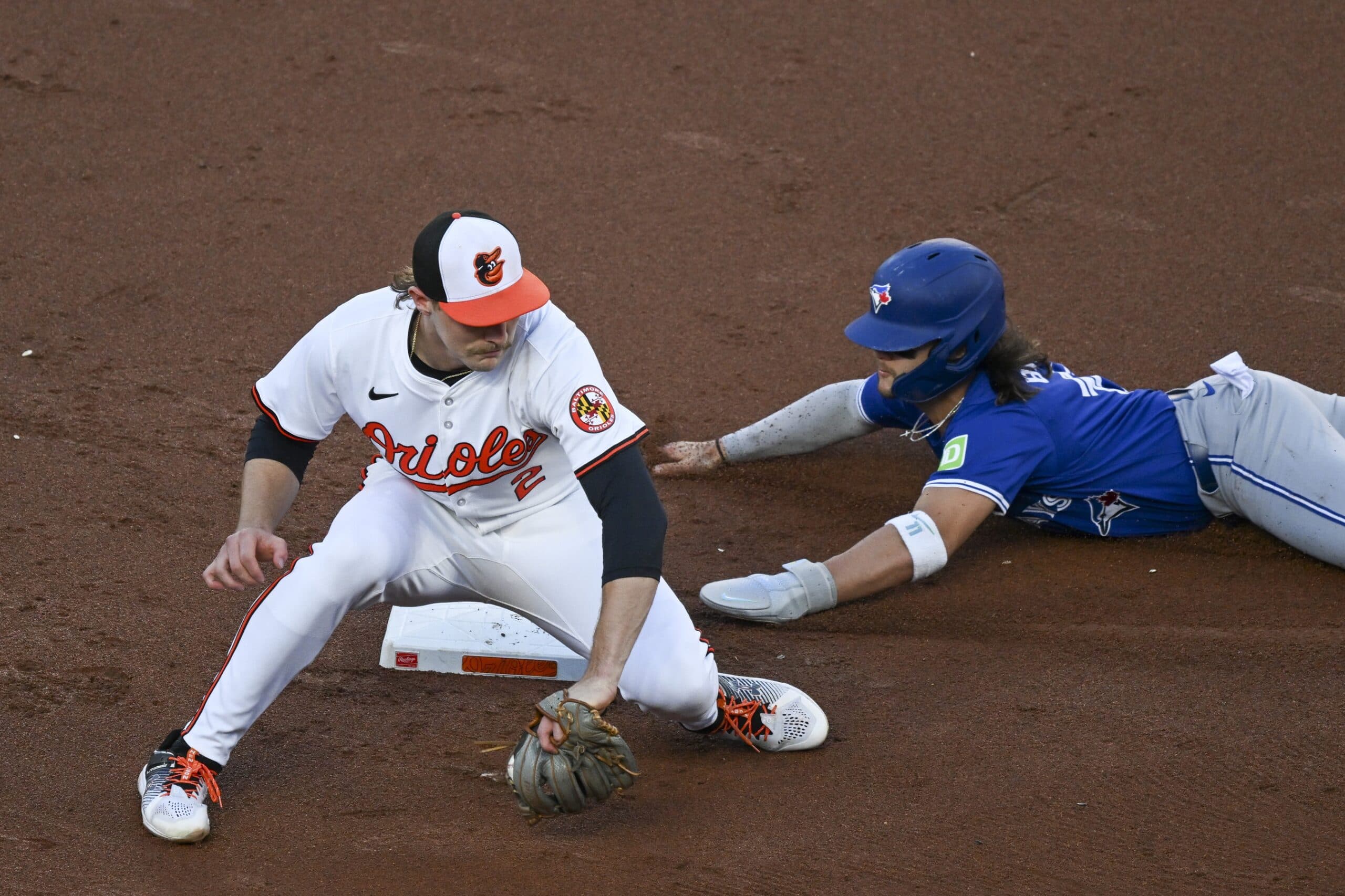 Toronto Blue Jays shortstop Bo Bichette (11) slides into second base before Baltimore Orioles shortstop Gunnar Henderson (2) can apply a tag on a second inning steal attempt at Oriole Park at Camden Yards