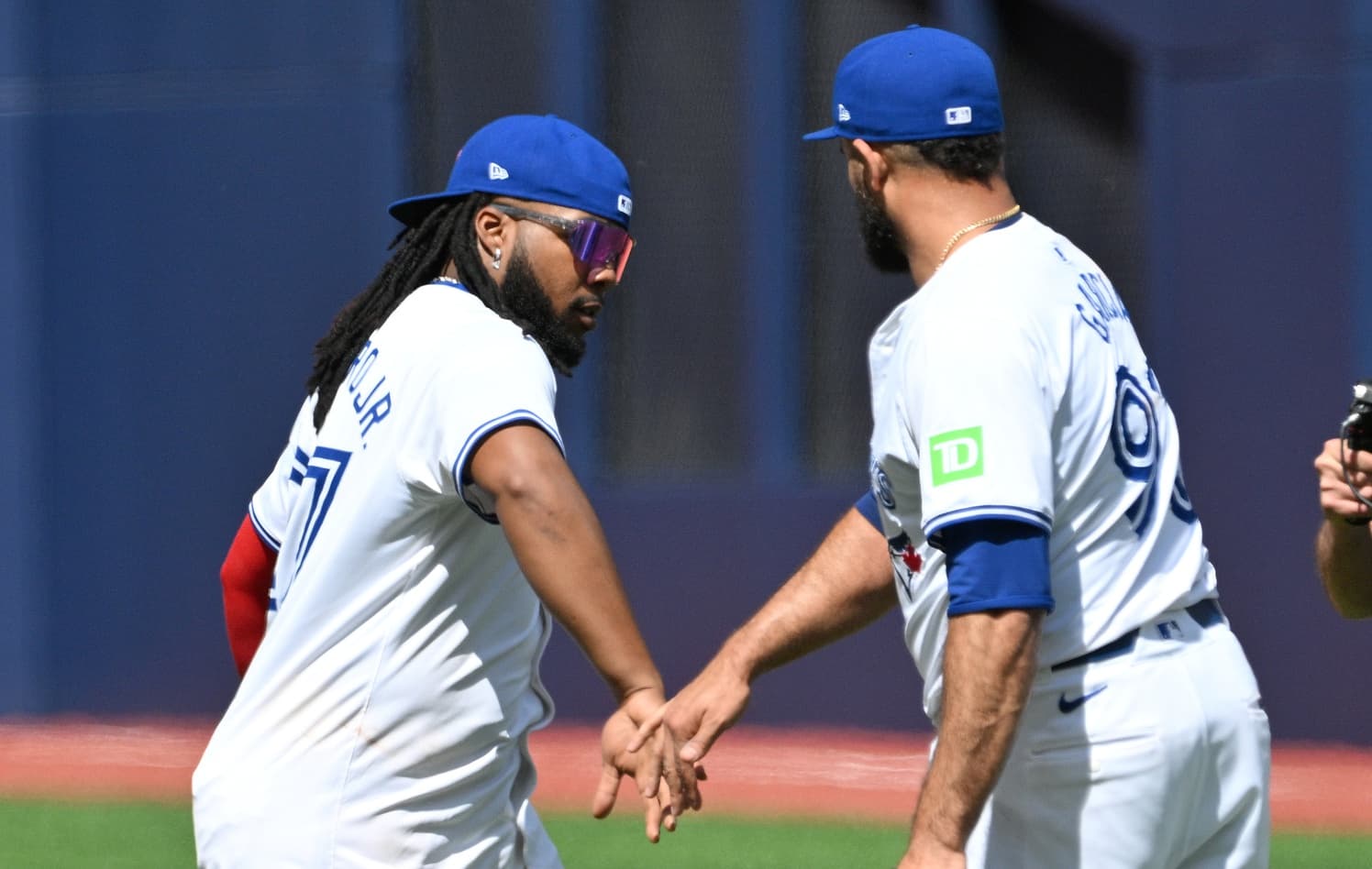 Toronto Blue Jays first baseman Vladimir Guerrero Jr. (27) slaps hands with relief pitcher Yimi Garcia (93) after a win over the Baltimore Orioles at Rogers Centre.