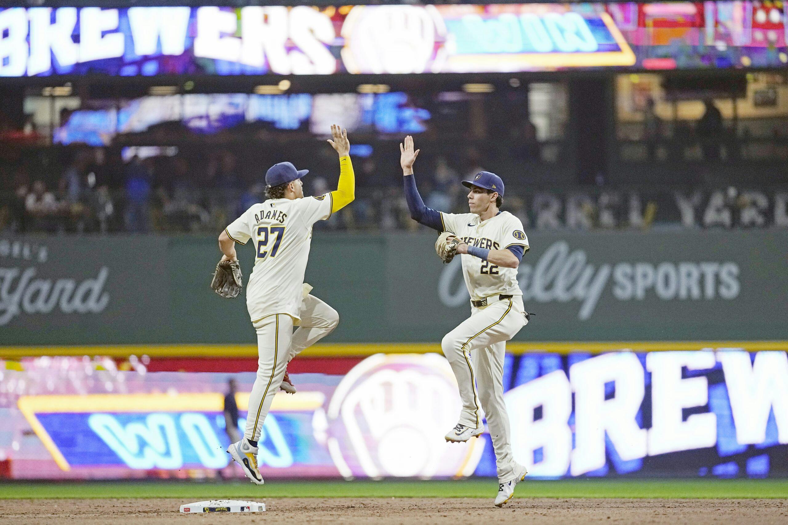 Milwaukee Brewers shortstop Willy Adames (27) and left fielder Christian Yelich (22) celebrate following the game against the Toronto Blue Jays at American Family Field.