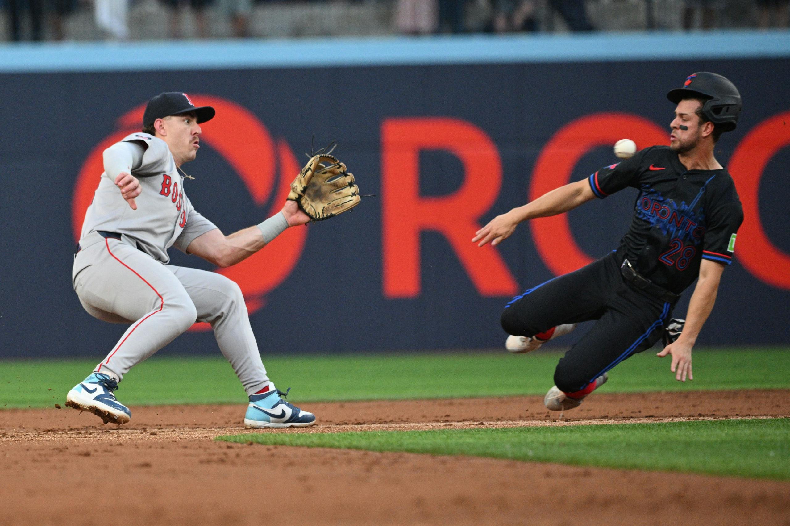 Boston Red Sox second baseman Romy Gonzalez (23) prepares to tag out Toronto Blue Jays third baseman Ernie Clement (28) on an attempted steal of second base in the second inning at Rogers Centre.