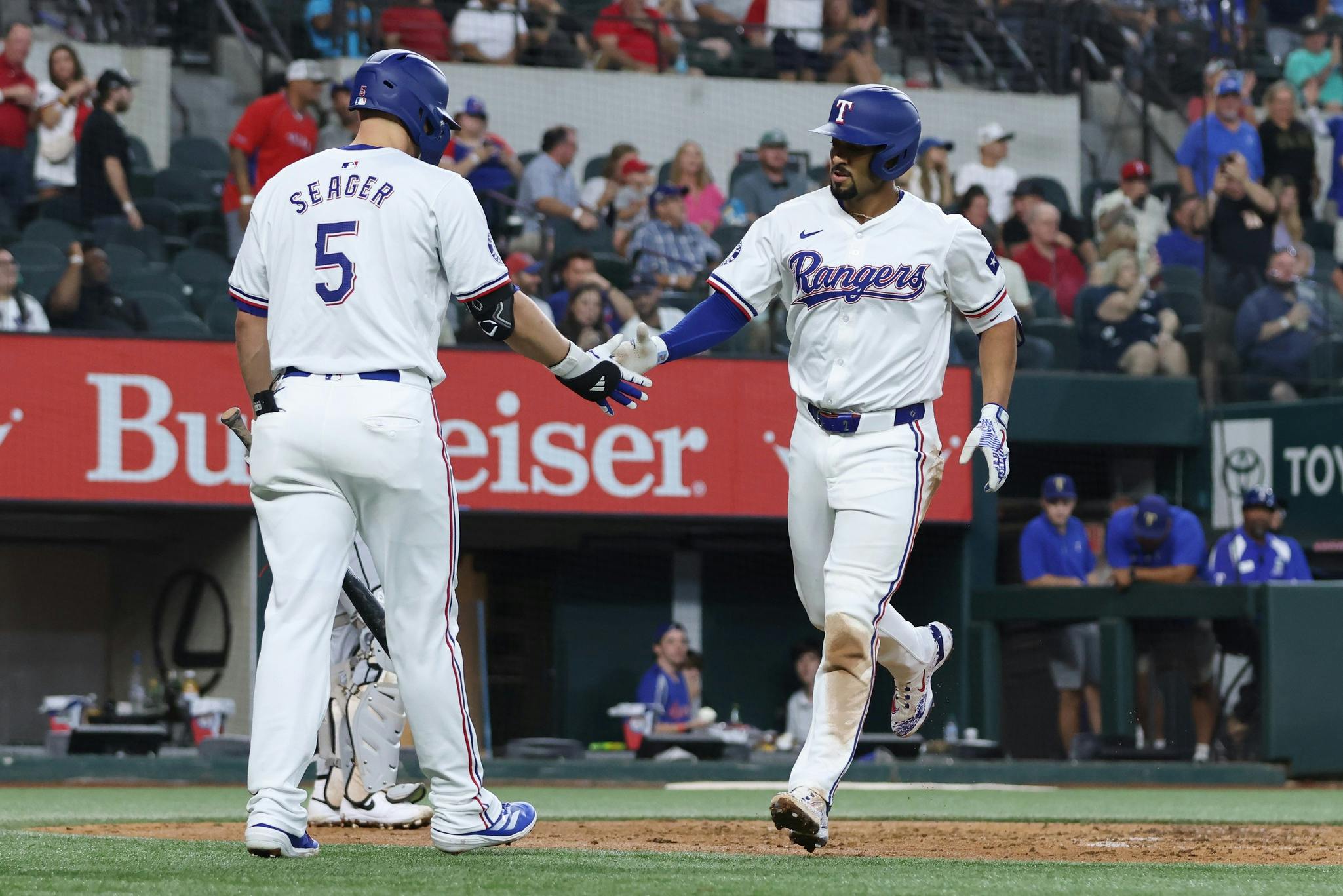 Texas Rangers second base Marcus Semien (2) celebrates with shortstop Corey Seager (5) after hitting a home run against the Chicago White Sox in the third inning at Globe Life Field.