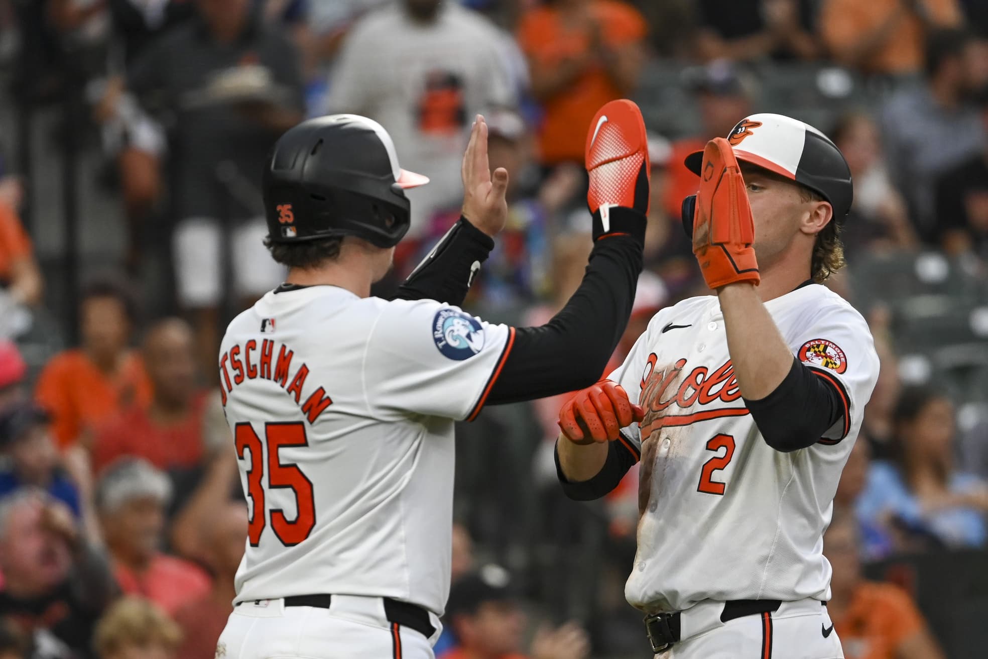 Baltimore Orioles catcher Adley Rutschman (35) celebrates with shortstop Gunnar Henderson (2) after scoring during the third inning against the Toronto Blue Jays at Oriole Park at Camden Yards.