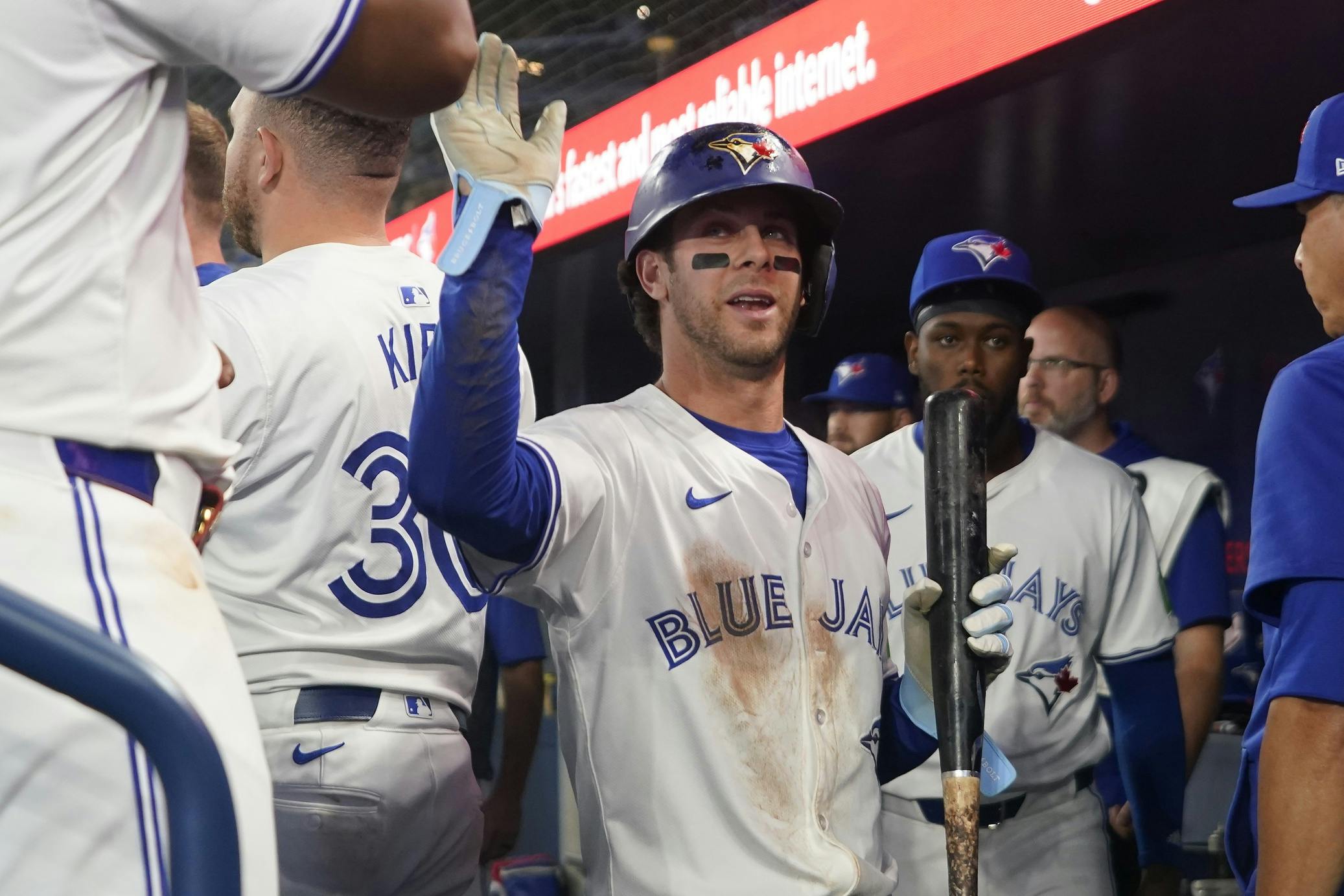 Toronto Blue Jays third baseman Ernie Clement (28) gets congratulated after scoring against the New York Mets during the second inning at Rogers Centre.