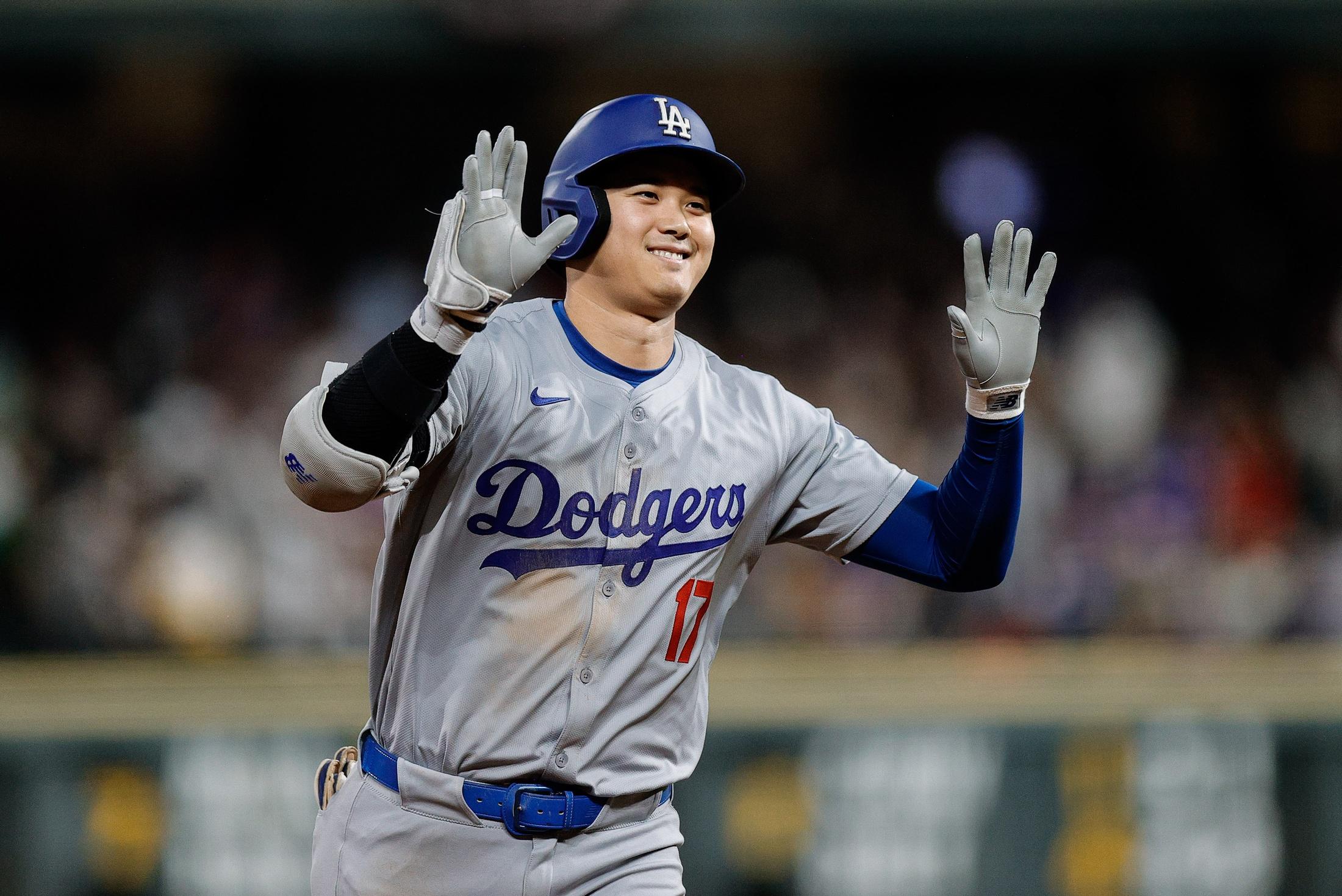 Los Angeles Dodgers designated hitter Shohei Ohtani (17) gestures as he rounds the bases on a three run home run in the sixth inning against the Colorado Rockies at Coors Field.