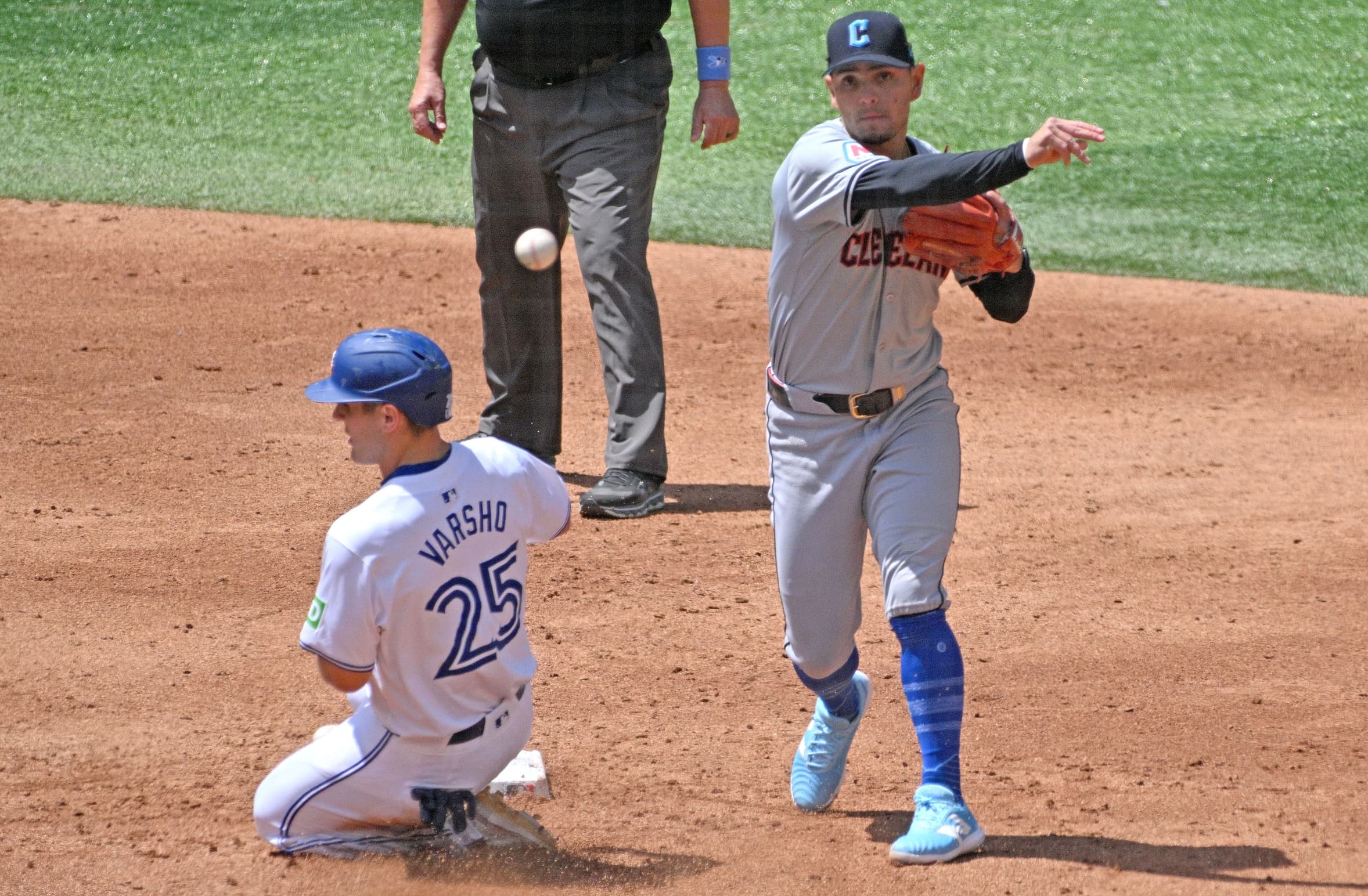 Cleveland Guardians second baseman Andres Gimenez (0) throws to first for a double play after forcing out Toronto Blue Jays centre fielder Daulton Varsho (25) in the third inning at Rogers Centre.