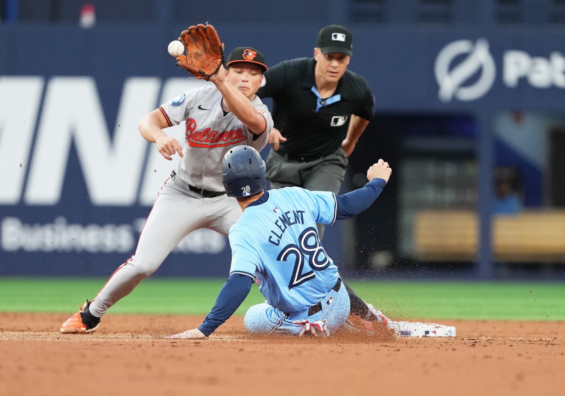 Toronto Blue Jays second baseman Ernie Clement (28) is tagged out at second base by Baltimore Orioles shortstop Gunnar Henderson (2) during the second inning at Rogers Centre.