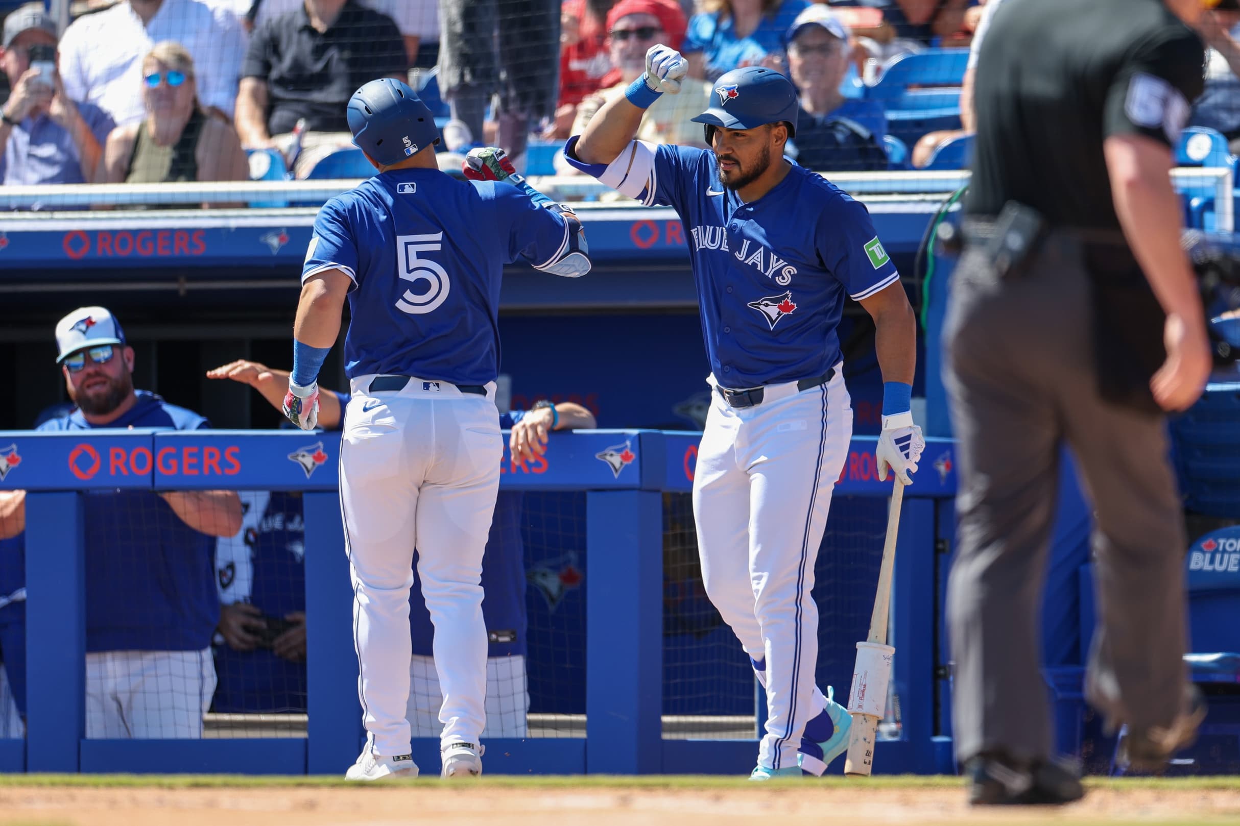 Toronto Blue Jays outfielder Anthony Santander (25) congratulates outfielder Daulton Varsho (5) after hitting home run against the Philadelphia Phillies in the first inning during spring training at TD Ballpark