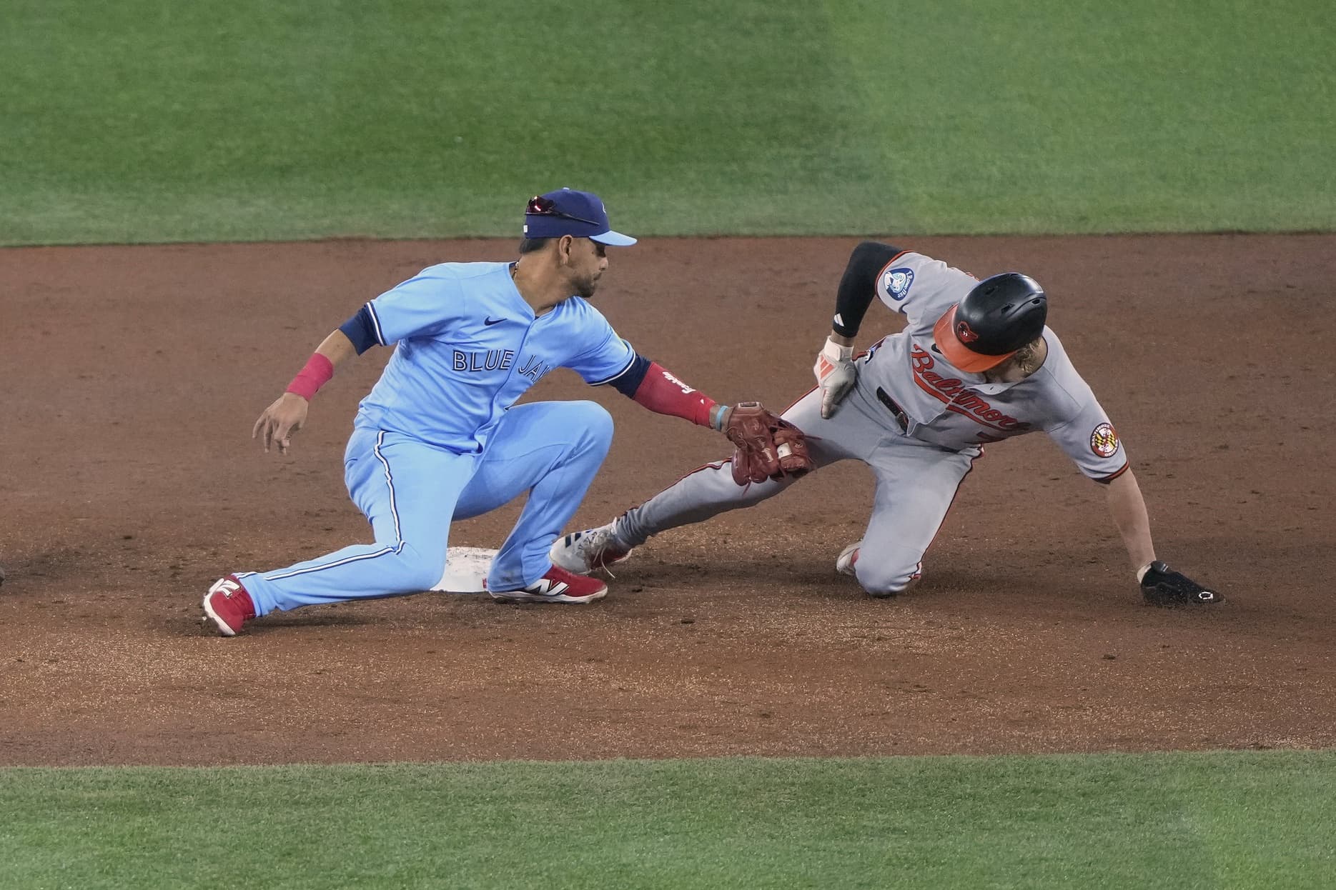Baltimore Orioles second baseman Jackson Holliday (7) steals second base against Toronto Blue Jays second baseman Andres Gimenez (0) during the second inning at Rogers Centre.