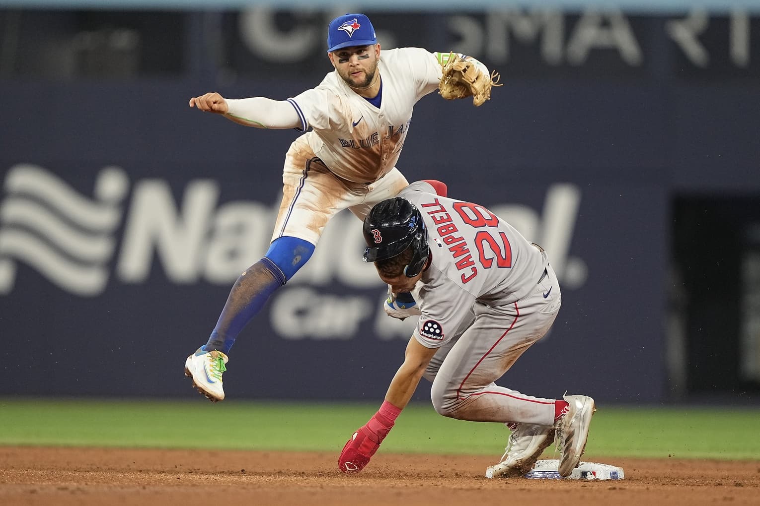 Toronto Blue Jays shortstop Bo Bichette (11) collides with Boston Red Sox second baseman Kristian Campbell (28) after turning a double play at second base and at first base against first baseman Triston Casas (not pictured) to end the fifth inning at Rogers Centre.