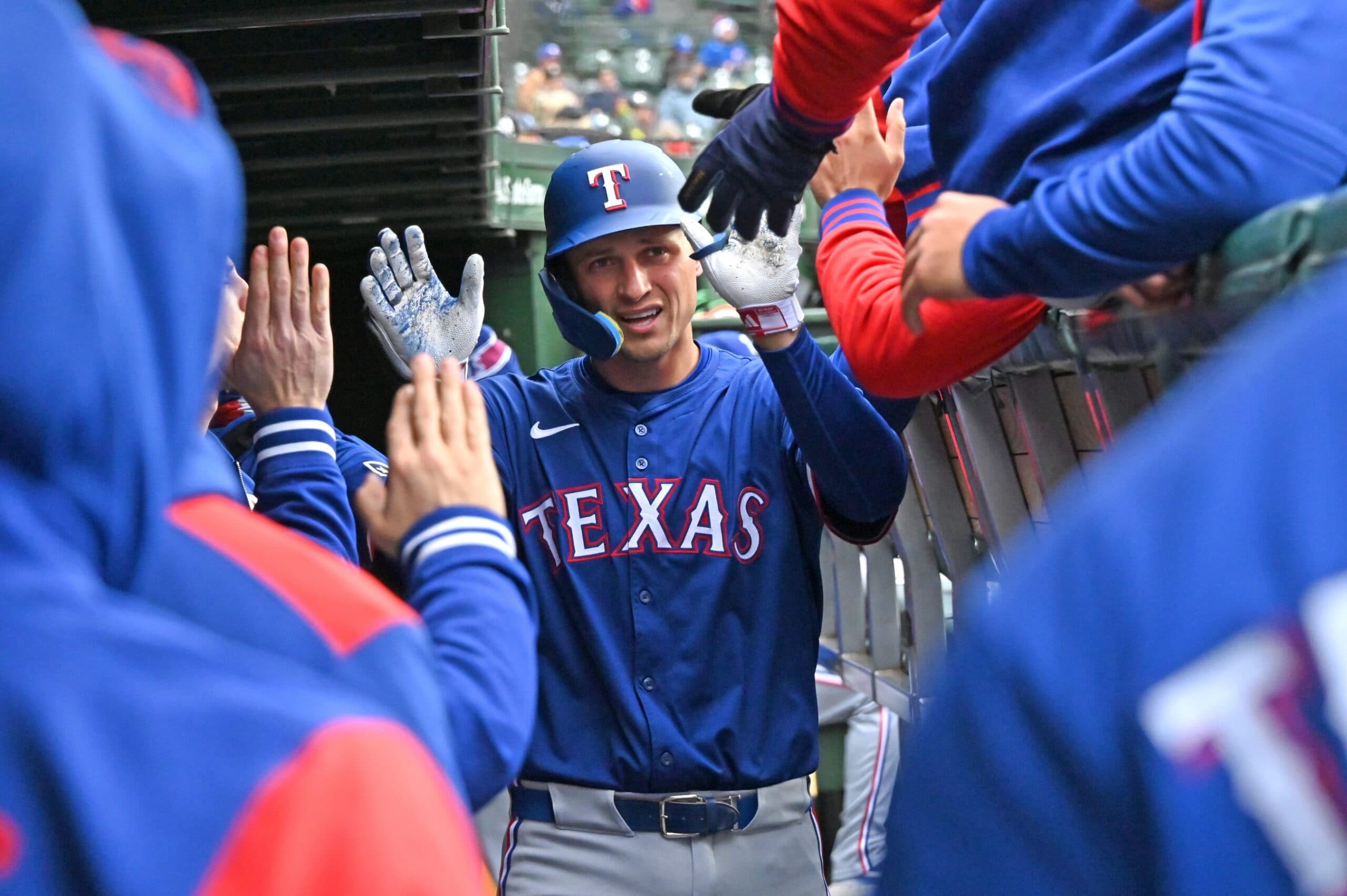 Texas Rangers shortstop Corey Seager (5) celebrates with teammates in the dugout after hitting a home run during the seventh inning against the Chicago Cubs at Wrigley Field.