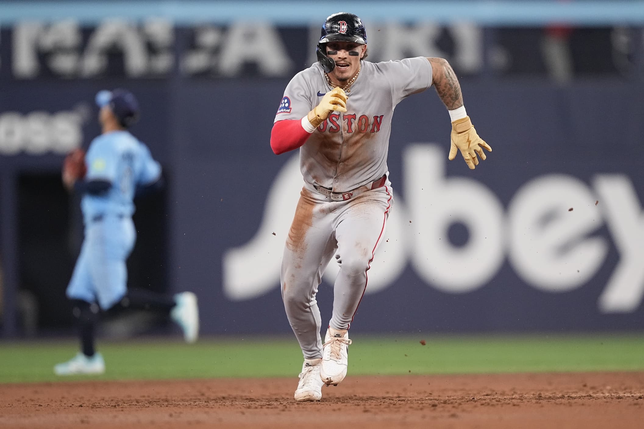 Boston Red Sox left fielder Jarren Duran (16) runs to thurd base on an overthrow at second base by the Toronto Blue Jays during the second inning at Rogers Centre.