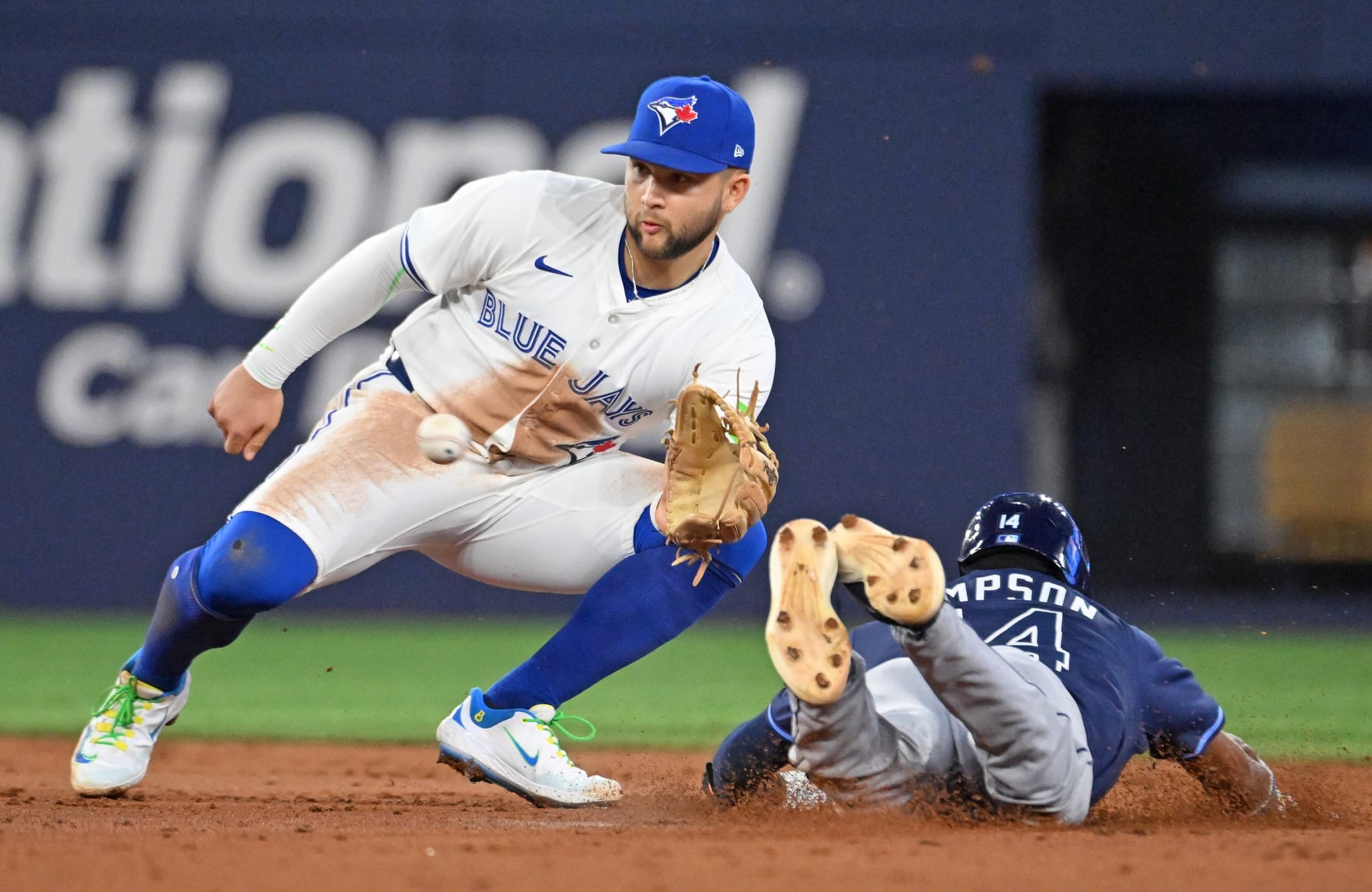 Toronto Blue Jays shortstop Bo Bichette (11) takes the throw from the plate before tagging out Tampa Bay Rays left fielder Chandler Simpson (14) who was trying to steal second base in the third inning at Rogers Centre.