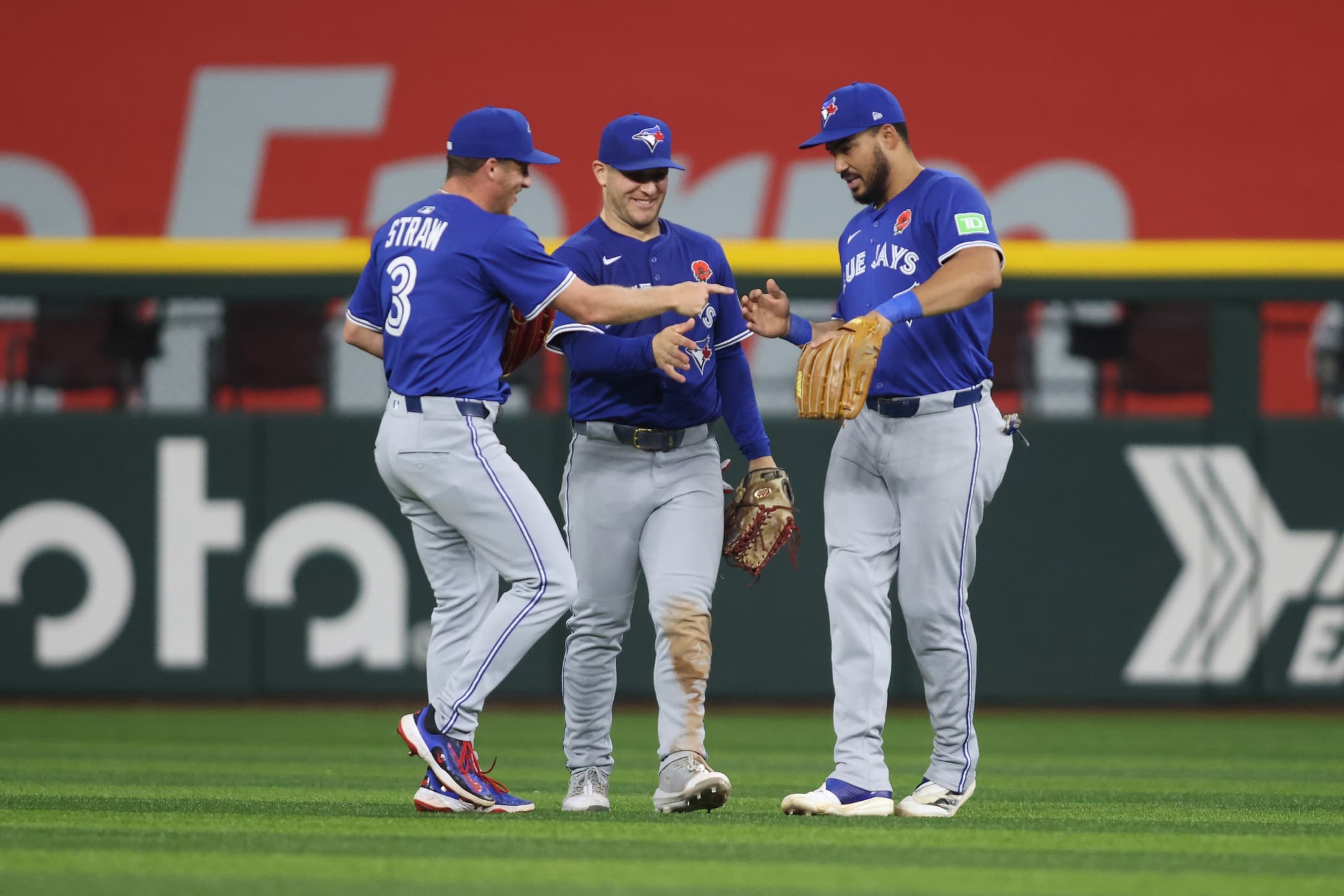 Toronto Blue Jays outfielder Myles Straw (3), outfielder Daulton Varsho (5) and outfielder Myles Straw (3) cerebrate after winning the game against the Texas Rangers at Globe Life Field
