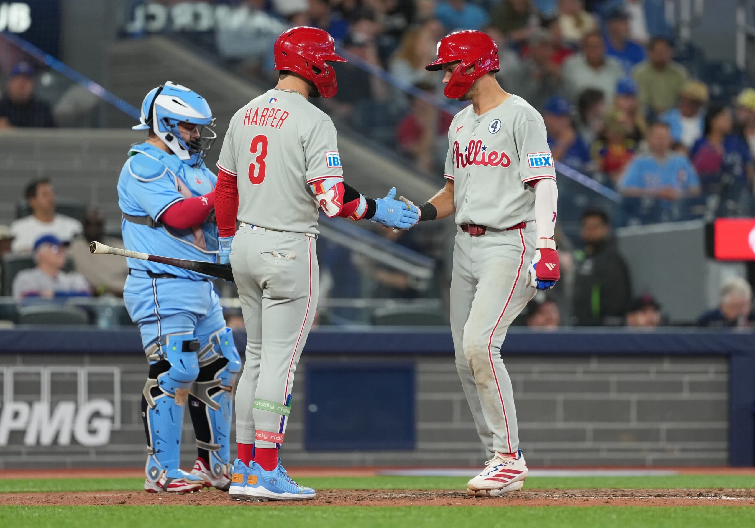 Philadelphia Phillies shortstop Trea Turner (7) hits a home run and celebrates with first baseman Bryce Harper (3) against the Toronto Blue Jays during the eighth inning at Rogers Centre