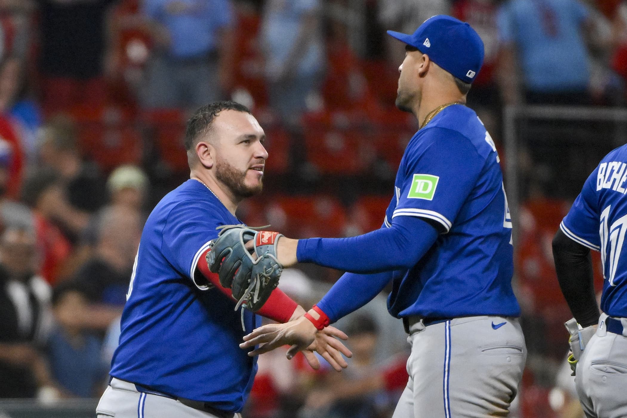 Toronto Blue Jays catcher Alejandro Kirk (30) celebrates with right fielder George Springer (4) after the Blue Jays defeated the St. Louis Cardinals in ten innings at Busch Stadium.