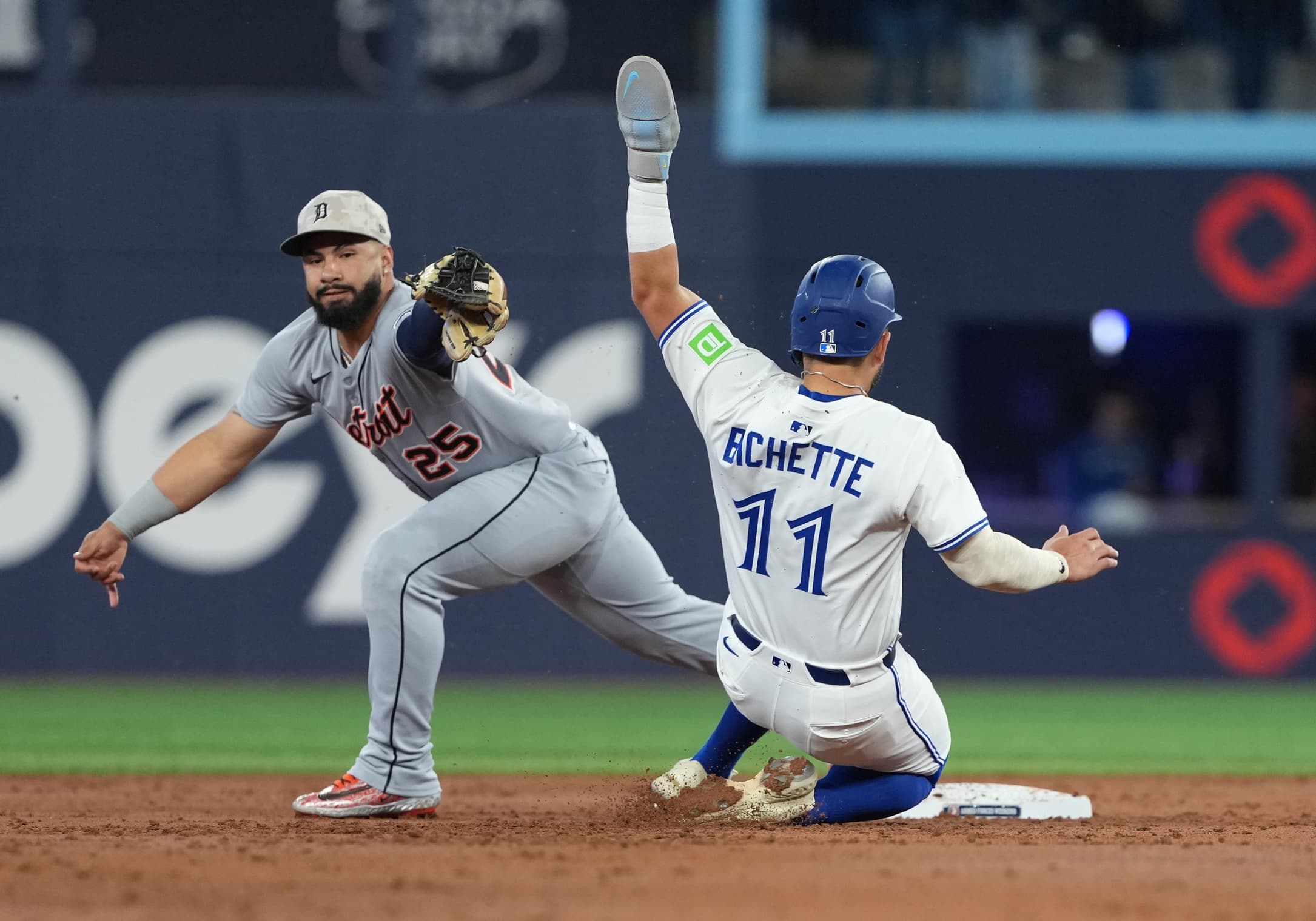 Toronto Blue Jays shortstop Bo Bichette (11) is tagged out at second base by Detroit Tigers second baseman Gleyber Torres (25) during the first inning at Rogers Centre.