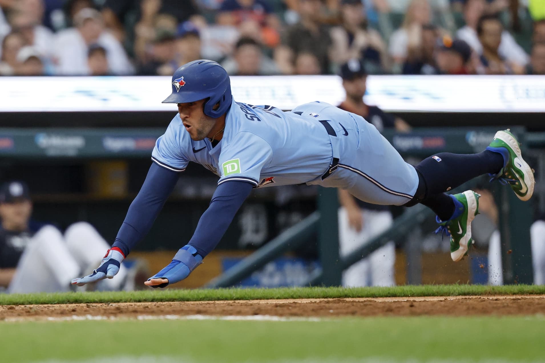 Toronto Blue Jays outfielder George Springer (4) dives in safe at home in the eighth inning against the Detroit Tigers at Comerica Park.