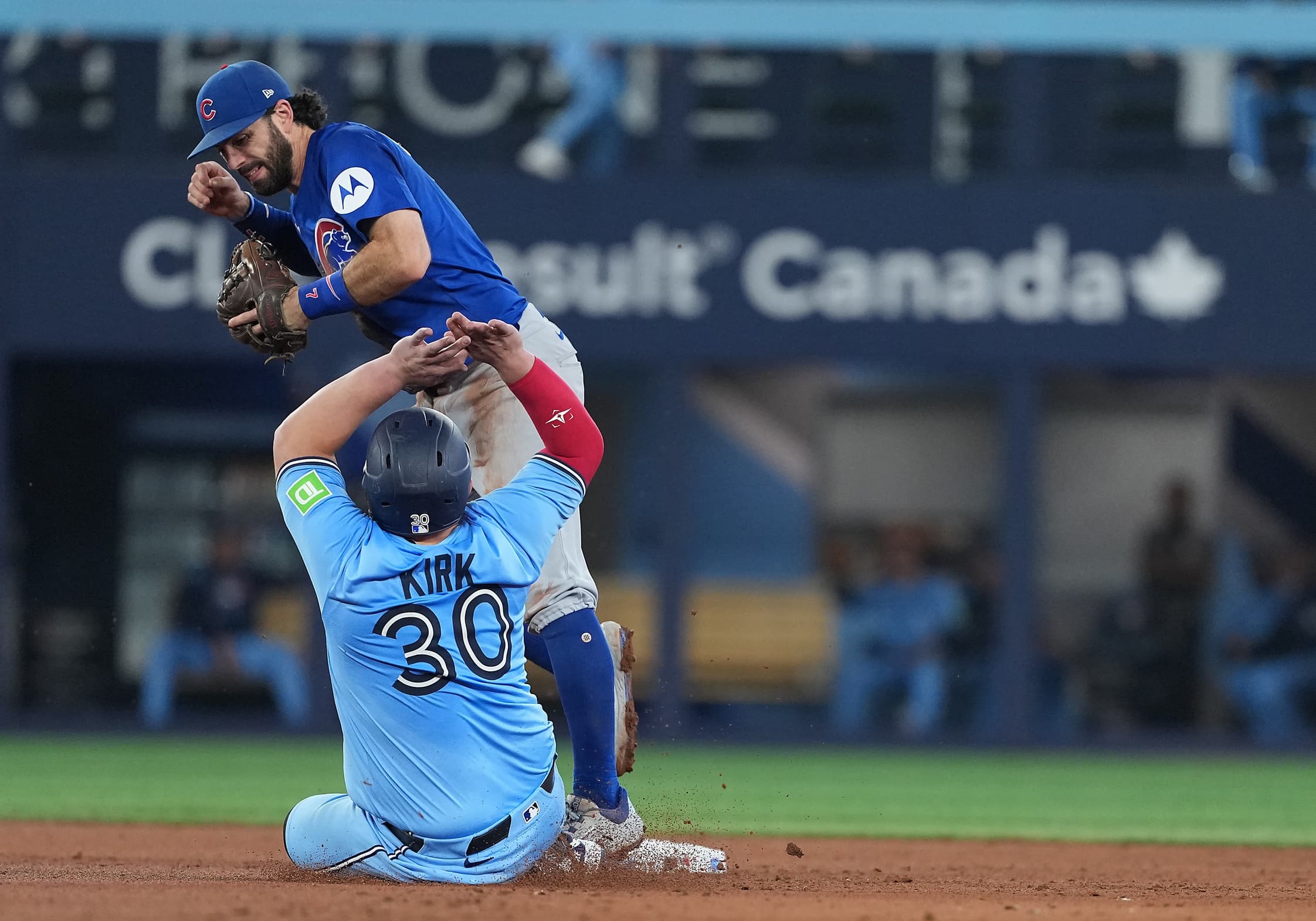 Toronto Blue Jays catcher Alejandro Kirk (30) is safe at second base ahead of the tag by Chicago Cubs shortstop Dansby Swanson (7) during the fifth inning at Rogers Centre.