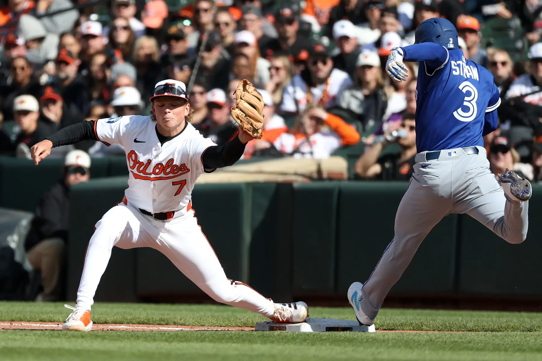 Toronto Blue Jays outfielder Myles Straw (3) is out at first on a sacrifice bunt against Baltimore Orioles second baseman Jackson Holliday (7) during the eighth inning at Oriole Park at Camden Yards.