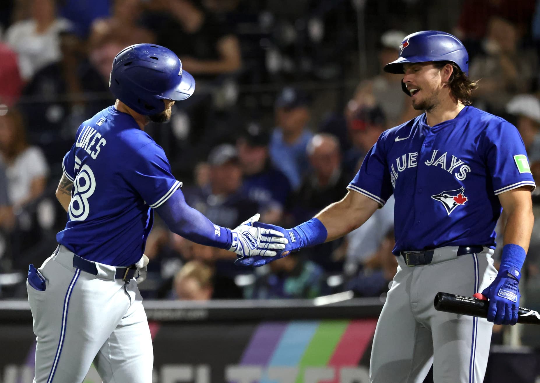 Toronto Blue Jays right fielder Nathan Lukes (38) is congratulated by third baseman Addison Barger (47) after he hit a home run during the fourth inning against the Tampa Bay Rays at George M. Steinbrenner Field.