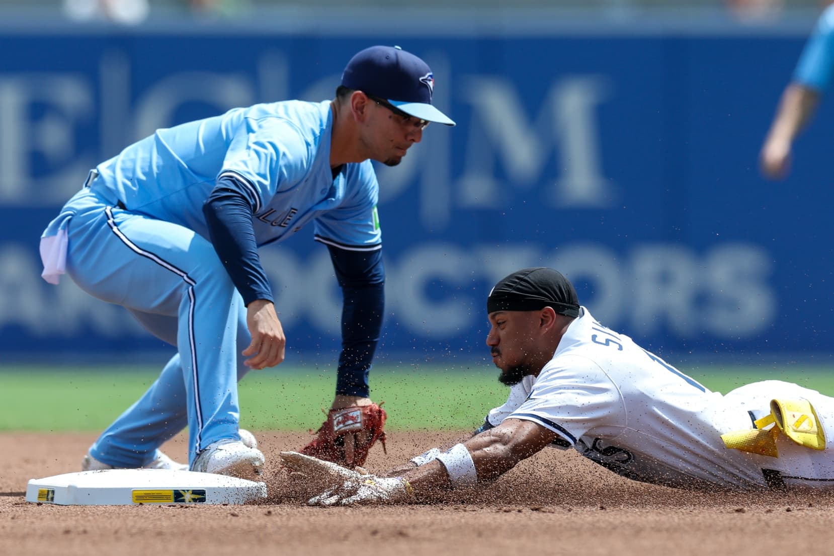 Tampa Bay Rays center fielder Chandler Simpson (14) slides into second base on a double against the Toronto Blue Jays in the first inning at George M. Steinbrenner Field