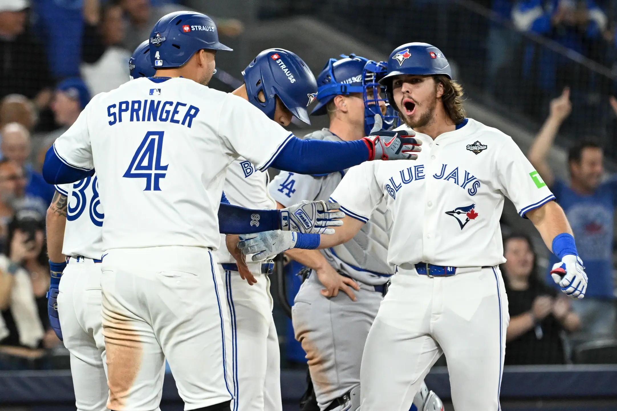 Toronto Blue Jays right fielder Addison Barger (47) celebrates with teammates after hitting a grand slam against the Los Angeles Dodgers in the sixth inning during game one of the 2025 MLB World Series at Rogers Centre
